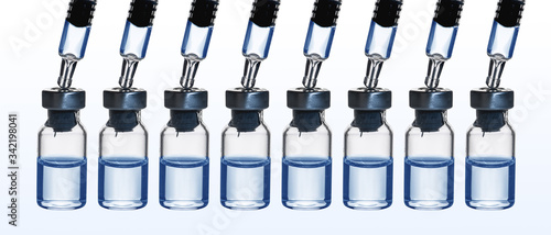 row of glass bottle of drug with syringe head in blue isolated on white background