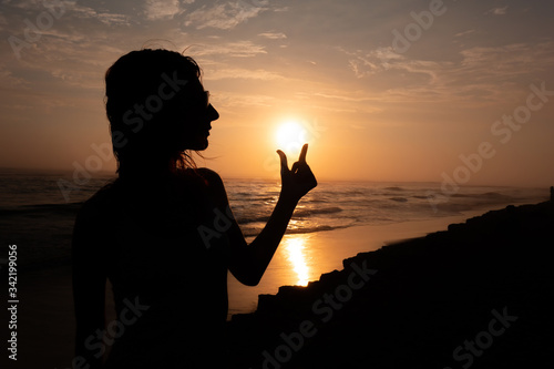 Woman with sunglasses silhouette and  sunset (ID: 342199056)