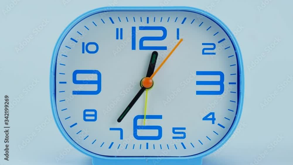 Closeup Zoom out, Blue Alarm clock shows time 12 o'clock, Time lapse moving fast, Time concept. Closeup Zoom out, Blue Alarm clock shows time 12 o'clock, Time lapse moving fast, Time concept.
