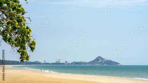 Fototapeta Naklejka Na Ścianę i Meble -  Empty beach with only one person in it during the time of corona virus. Travel ban and corona virus containment measures have emptied beaches in Thailand.