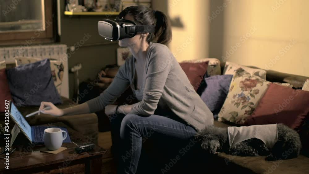 Young graphic designer is working on drawing tablet with VR glasses Young graphic designer is working on drawing tablet with VR glasses
