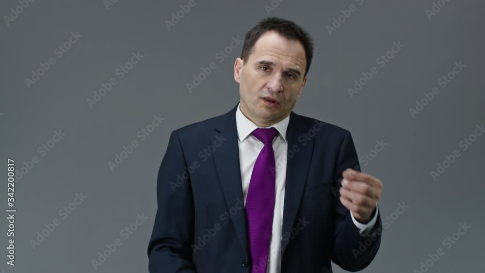 Overworked handsome middle aged office worker in formal clothes, tie feels tired, takes off glasses, holding hand on bridge of his nose on isolated grey background, people emotions concept Overworked handsome middle aged office worker in formal clothes, tie feels tired, takes off glasses, holding hand on bridge of his nose on isolated grey background, people emotions concept