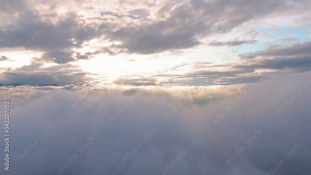 Aerial flying above stratus clouds during beautiful sunset background Aerial flying above stratus clouds during beautiful sunset background
