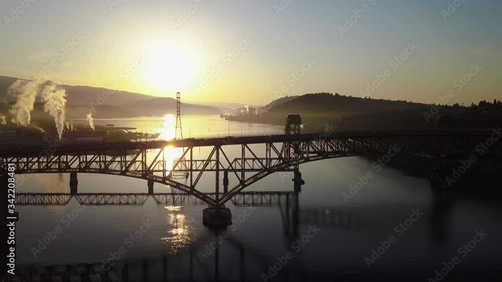 The Stunning View Of Ironworkers Memorial Bridge In Vancouver, BC Canada With A Beautiful Yellow Morning Sunrise Background - Wide Shot (forward) The Stunning View Of Ironworkers Memorial Bridge In Vancouver, BC Canada With A Beautiful Yellow Morning Sunrise Background - Wide Shot (forward)