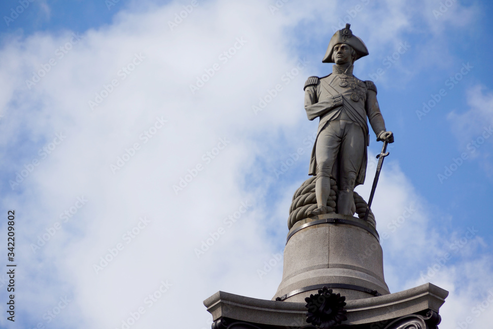 Fototapeta premium Lord Nelson statue close up at Trafalgar square in London with copy space in the sky