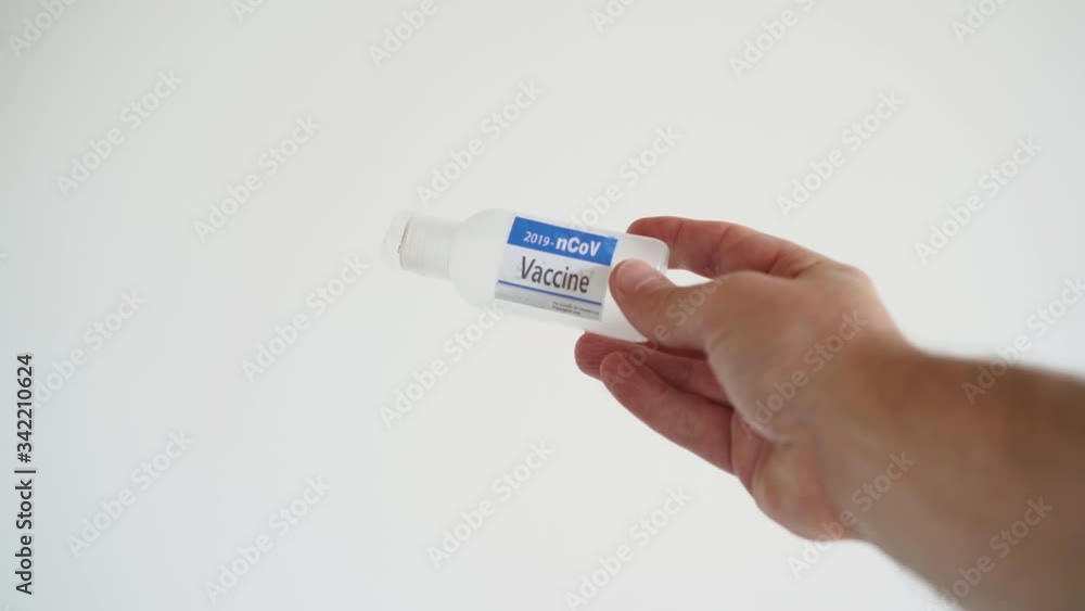 Hand on white background showing fake vaccine for Covid-19 disease Hand on white background showing fake vaccine for Covid-19 disease