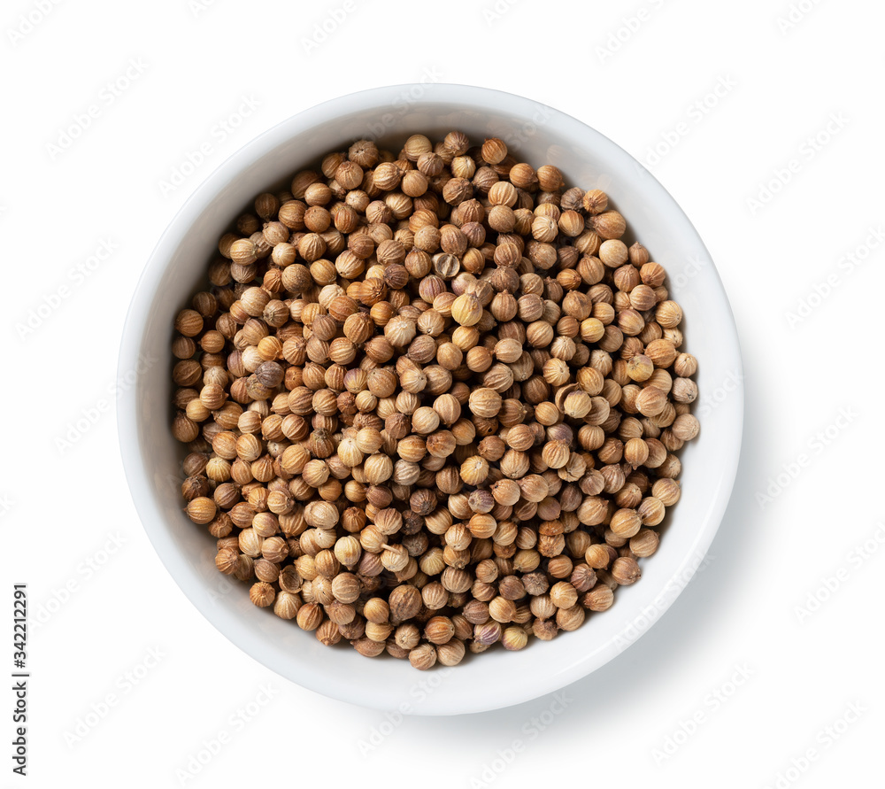 Coriander seeds in a plate placed on a white background Coriander seeds in a plate placed on a white background