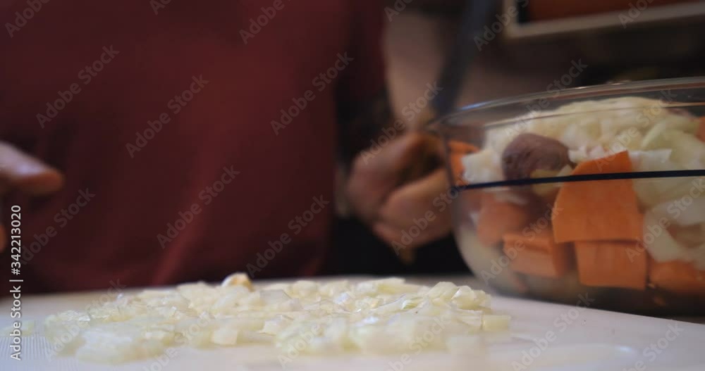 close up, adding sliced onion to various chopped vegetables in a bowl close up, adding sliced onion to various chopped vegetables in a bowl