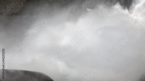 Extreme view of the water splashing in the waterfall of pailon del diablo. Extreme conditions during the largest flow in a long time in the pastaza river, Baños, Ecuador. photo