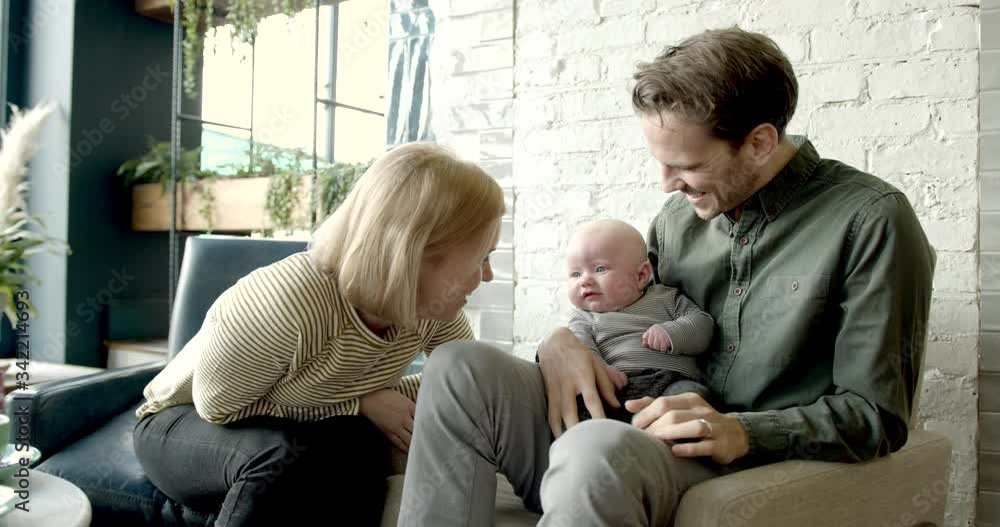 Couple with baby relaxing in trendy cafe restaurant together, family weekend activities Couple with baby relaxing in trendy cafe restaurant together, family weekend activities