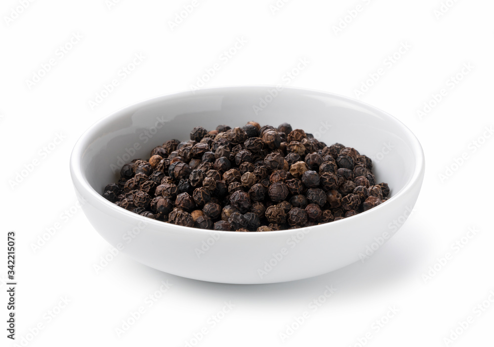 Black pepper in a plate placed on a white background Black pepper in a plate placed on a white background