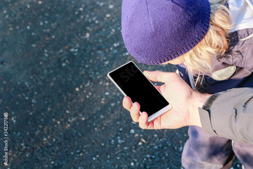 dad and boy child at the street, looking at mobile device cellphone screen