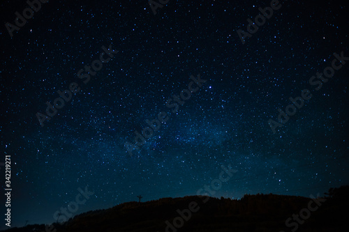 Fototapete Night landscape with starry sky. Astrology, space