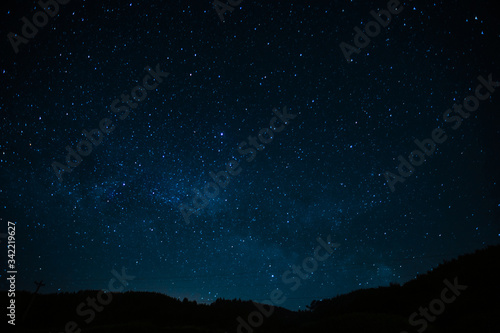 Night photograph depicting stars. Night cosmic sky. Astrophotography.