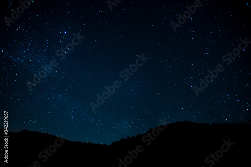 Night photograph depicting stars. Night cosmic sky. Astrophotography.