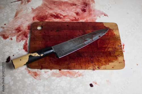 knife with grunge of blood on wood floor, halloween bloody murder or death crime killer violation concept.