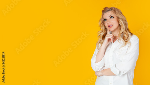 Curious modern stylish caucasian blond woman sideways look thinking make a choice thinking thinking delighted smile widely
