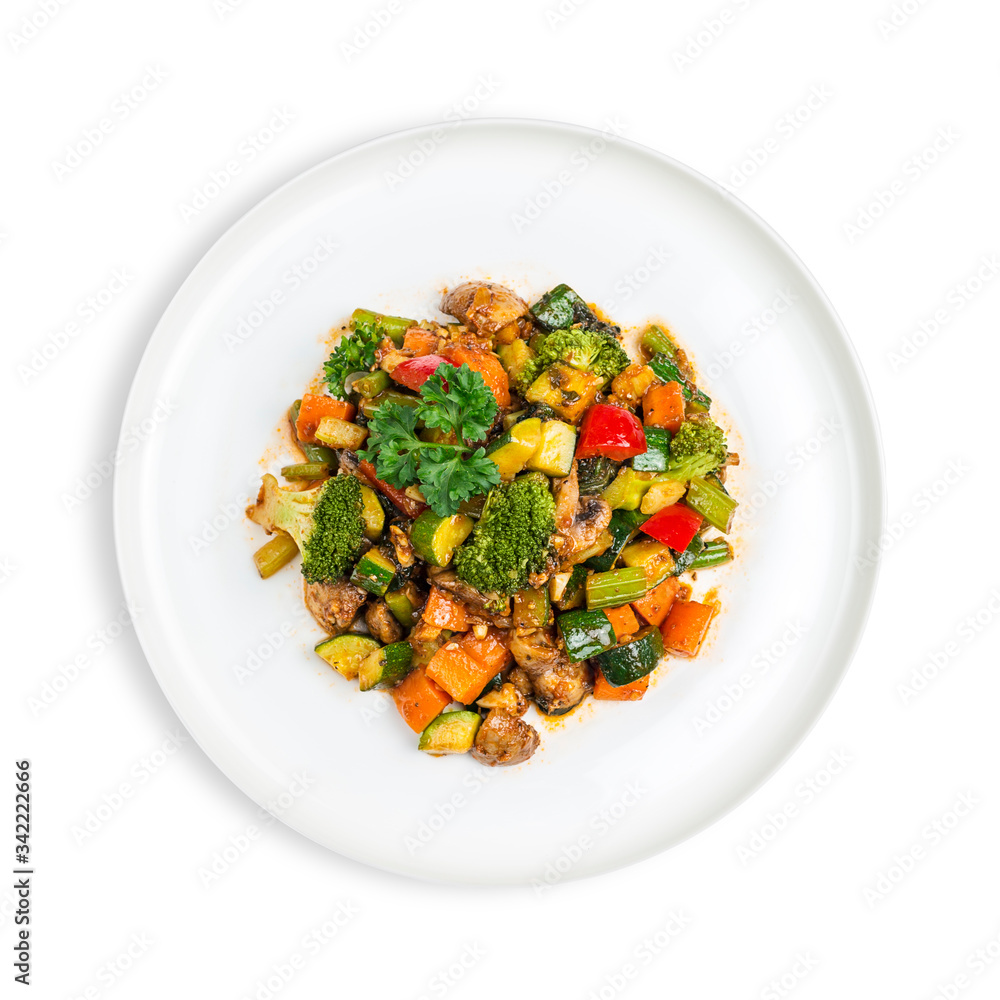 Plate of Vegan vegetable and mushroom stir-fry with carrots, broccoli, zucchini and capsicum isolated on white Plate of Vegan vegetable and mushroom stir-fry with carrots, broccoli, zucchini and capsicum isolated on white