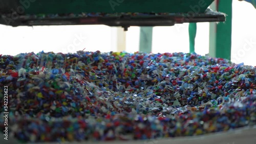 Multicolored PET flakes packed in a big bag. Close up.