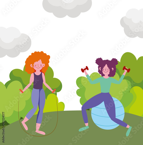young women training in park with jump rope, dumbbell and ball