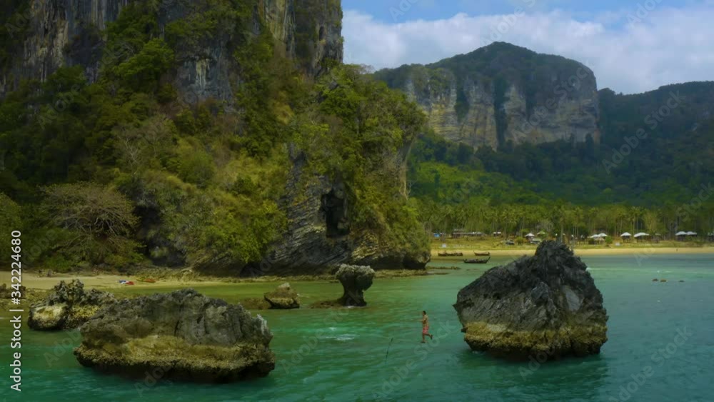 Man walking on rope between rocks slackline dangerous Cinematic drone 4k ocean nature green summer b-roll background Thailand tropical beach blue water amazing art Man walking on rope between rocks slackline dangerous Cinematic drone 4k ocean nature green summer b-roll background Thailand tropical beach blue water amazing art