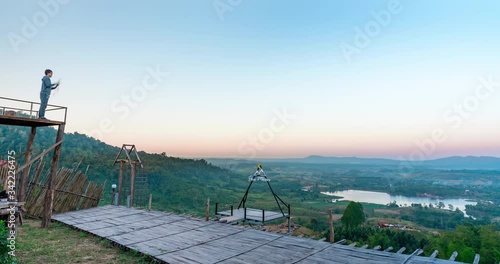 High view Time lapse Landscape Sunrise with mountain, hill with trees, blue sky with mist.