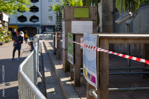 Wallpaper Mural Red and white caution tape wrapped around outdoor eating area of cafe in Carlsplatz closed during global quarantine from COVID-19. Lockdown  and quarantine time in epidemic of COVID-19 Virus crisis. Torontodigital.ca