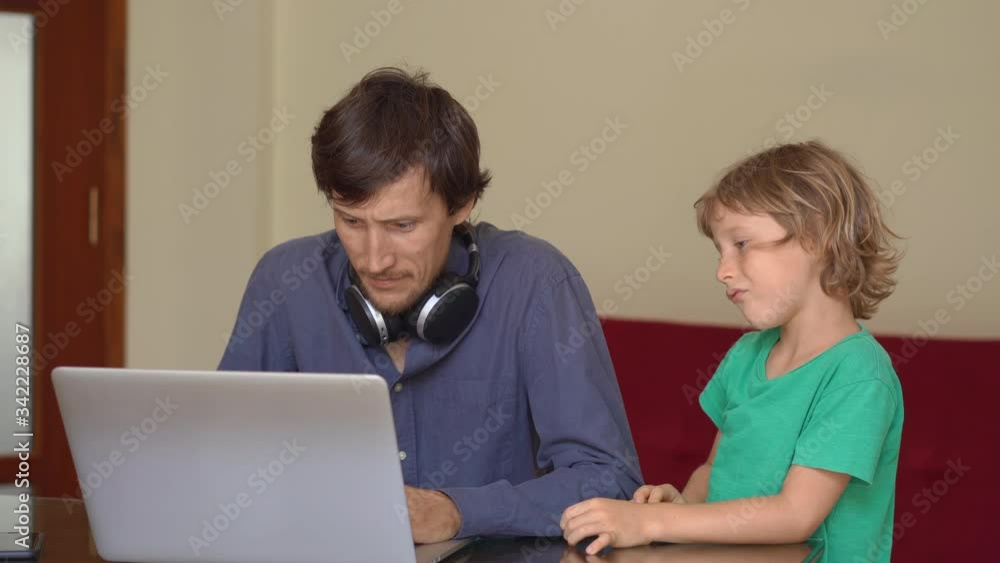 During quarantine man is trying to work remotely from home, but his son disturbes him. Children and parents conflicts during self-isolation During quarantine man is trying to work remotely from home, but his son disturbes him. Children and parents conflicts during self-isolation