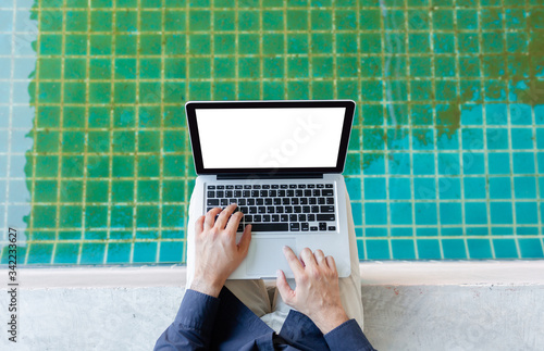 hand close up young asia business man, Happy young man working on laptop,at his working from home,Mock up copy space,Beside the pool