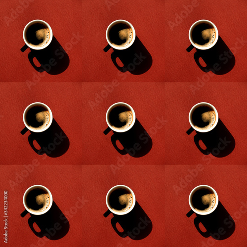 Cup full of coffee with harsh shadows on a vivid red background. Top view.