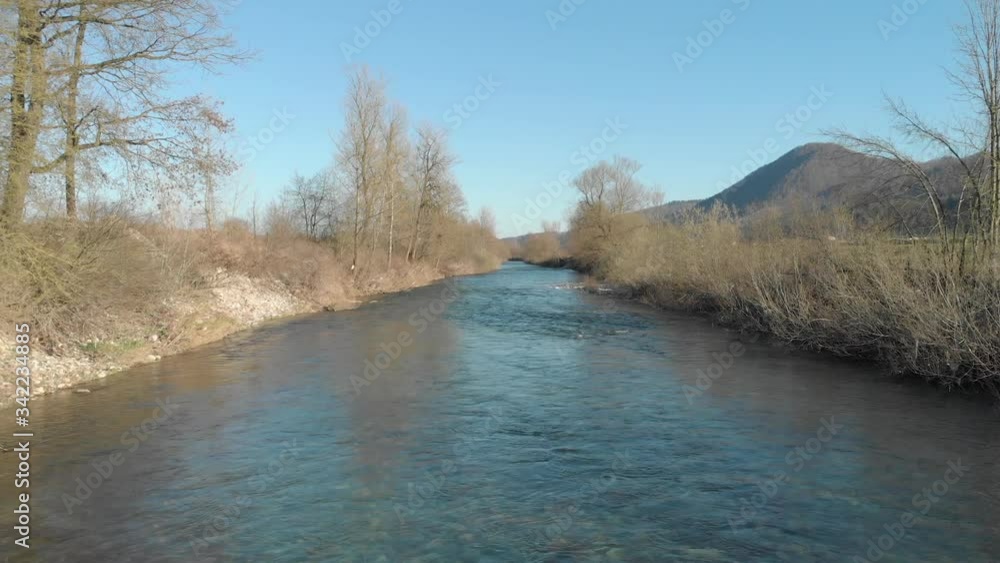 Dron flying above the slow river water with peaceful background Dron flying above the slow river water with peaceful background