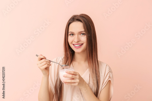 Young woman with tasty yogu...
