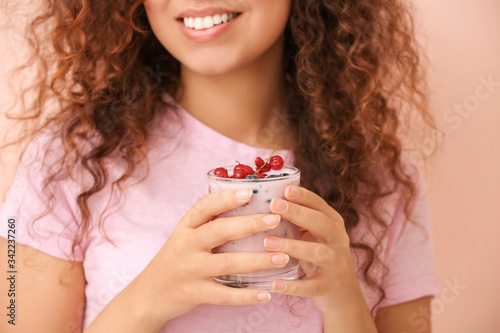 Young woman with tasty yogu...