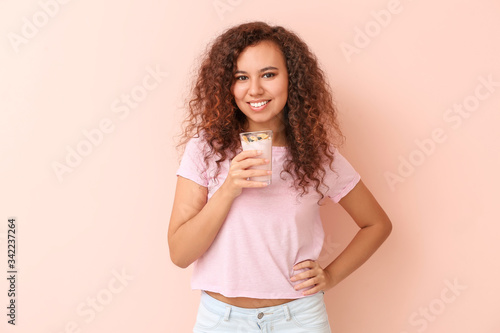 Young woman with tasty yogu...