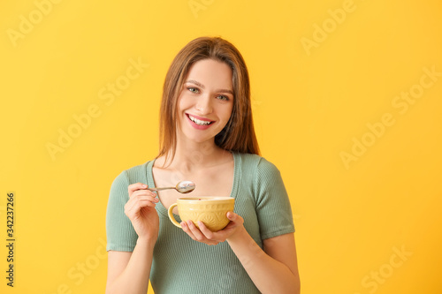 Young woman with tasty yogu...