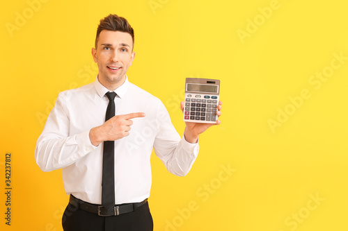 Young man with calculator o...