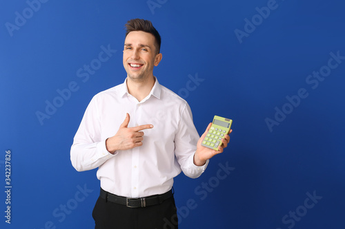 Young man with calculator o...