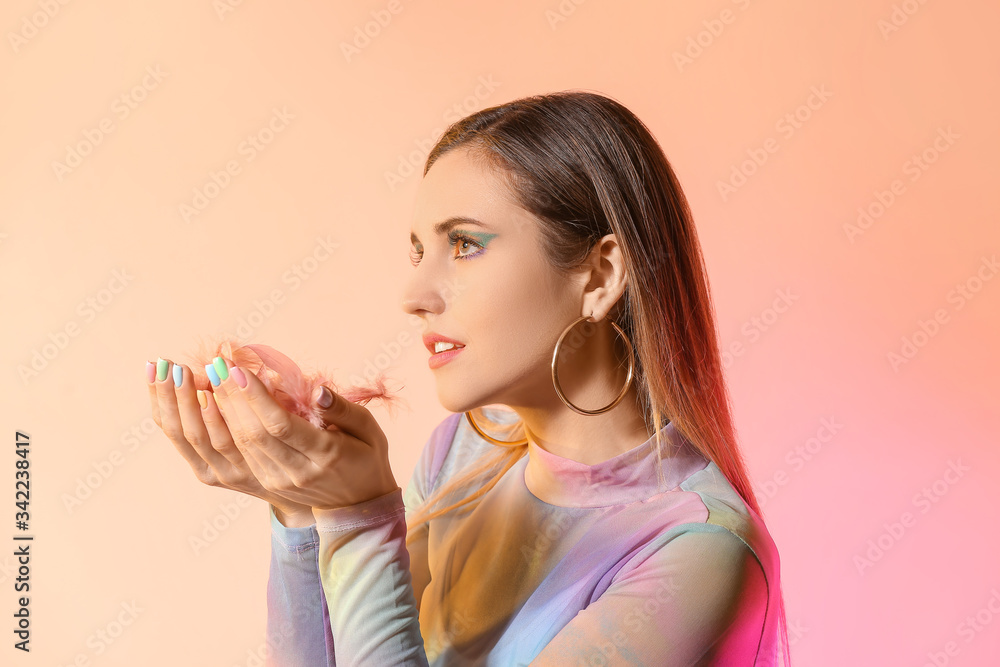 Young woman with beautiful manicure and feathers on color background Young woman with beautiful manicure and feathers on color background