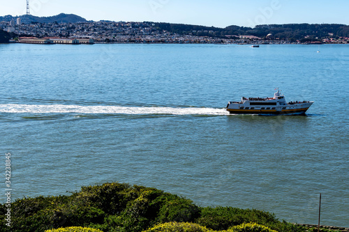 Tourist ferry boat while crossing the bay of San Francisco California with Downtown San Francisco Skyline, USA,  March 30, 2020