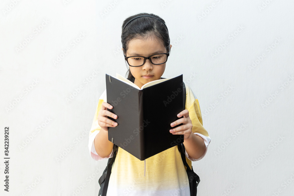 Asian girl elementary school with book and bag. Back to school. education concept Asian girl elementary school with book and bag. Back to school. education concept