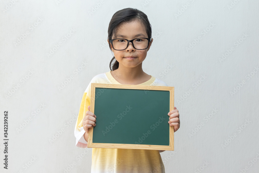 Asian girl holding empty board. Concept of education Asian girl holding empty board. Concept of education