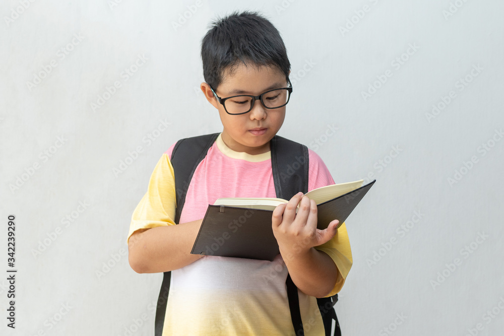 Asian boy elementary school with book and bag. Back to school. education concept Asian boy elementary school with book and bag. Back to school. education concept