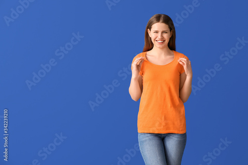 Young woman in stylish t-shirt on color background