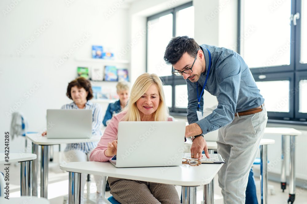 Group of senior people attending computer and technology education class. Group of senior people attending computer and technology education class.