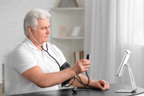 Elderly man video chatting ...