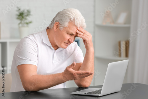 Elderly man video chatting ...