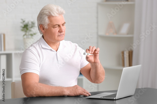 Elderly man video chatting ...