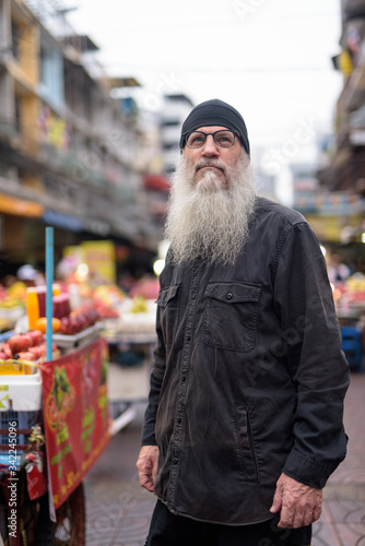 Mature bearded tourist man with eyeglasses thinking in Chinatown © Ranta Images
