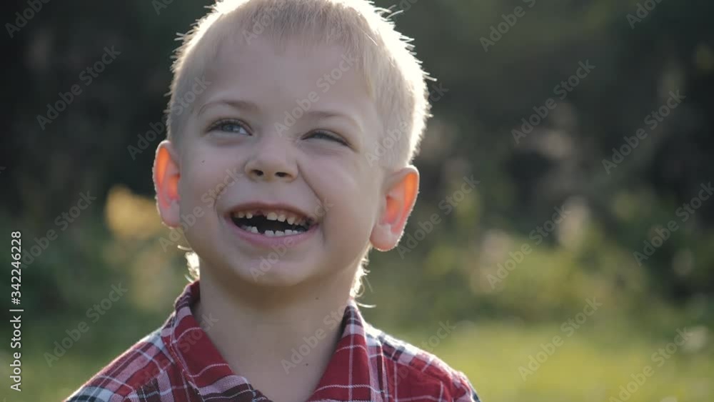 Portrait of a little toothless boy smiling at the camera. The boy is fooling around in front of the camera Portrait of a little toothless boy smiling at the camera. The boy is fooling around in front of the camera