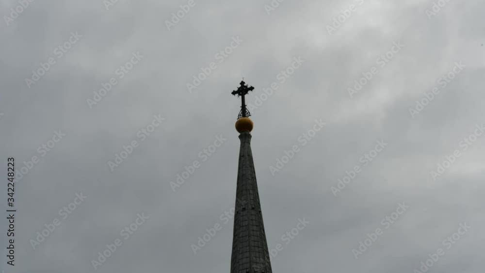Church Spire and Gray Clouds Time-lapse; a church spire with a cross on the top and grays clouds moving. Church Spire and Gray Clouds Time-lapse; a church spire with a cross on the top and grays clouds moving.